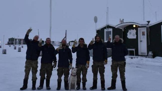 Members if the Sirius Dog Sled Squad fat one of their bases in northern Greenland, where the sun hasn’t risen since November.