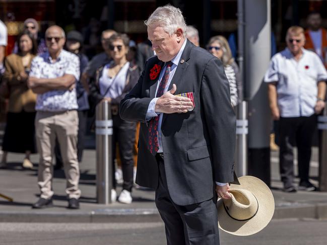 Colonel Jason Cooke RSL chief Marshall for Anzac Day listens to the Last Post outside Flinders St station. Picture: Wayne Taylor