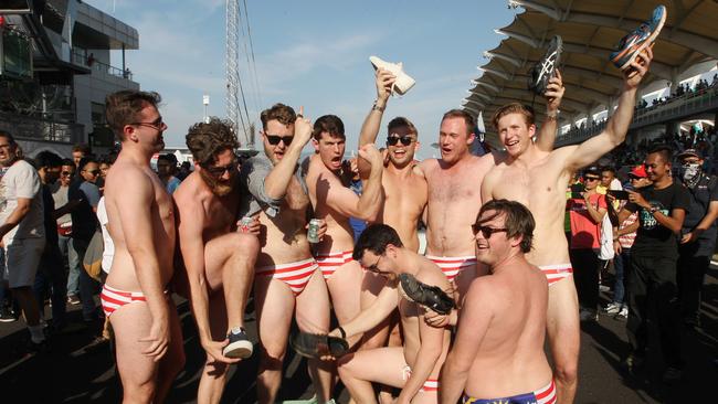 A group of nine Australian men celebrate at the conclusion of the Malaysian Formula One Grand Prix in Sepang, Malaysia. Picture: AP