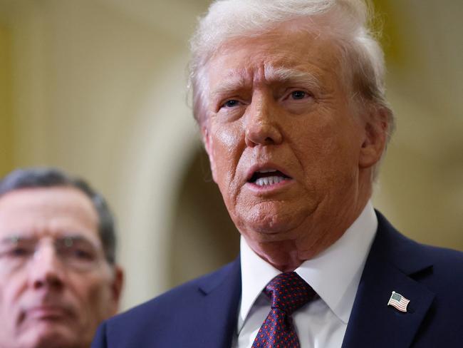 US Senator John Barrasso (R-WY) watches US President-elect Donald Trump speak to the press after paying their respects in front of the flag-draped casket at the Lying in State Ceremony for former President Jimmy Carter at the US Capitol Rotunda in Washington, DC on January 8, 2025. Carter, the 39th President of the United States, died at the age of 100 on December 29, 2024 at his home in Plains, Georgia. (Photo by Ting Shen / AFP)