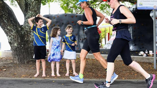 Grayson Coleman, 10, Alexis Johnstone, 6, Capri Coleman, 6, cheer on the triathletes on the Esplanade at the Ironman Cairns race. Picture: Brendan Radke