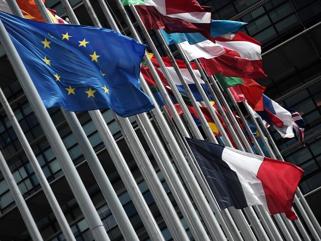 This photo taken on July 15, 2016 shows the French and European Union flags flying at half-mast in front of the European Parliament building in Strasbourg, eastern France, on July 15, 2016, the day after a gunman smashed a truck into a crowd of revellers celebrating Bastille Day in Nice, killing at least 84 people. A Tunisian-born man zigzagged a truck through a crowd celebrating Bastille Day in the French city of Nice, killing at least 84 and injuring dozens of children in what President Francois Hollande on July 15 called a "terrorist" attack. / AFP PHOTO / FREDERICK FLORIN