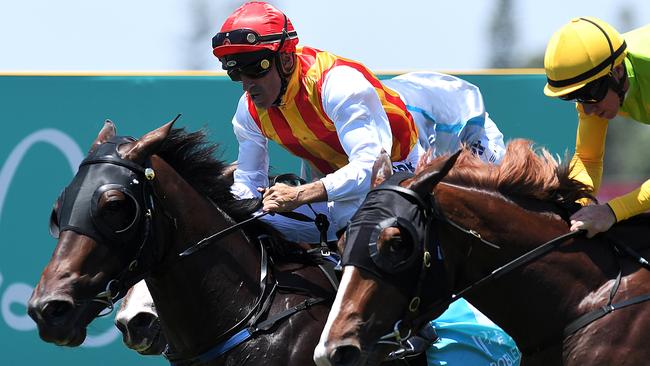Jockey Robbie Fradd rides Problem Solver (left) to win the Magic Millions Maiden Plate at Aquis Park. Picture: Albert Perez, AAP Image.