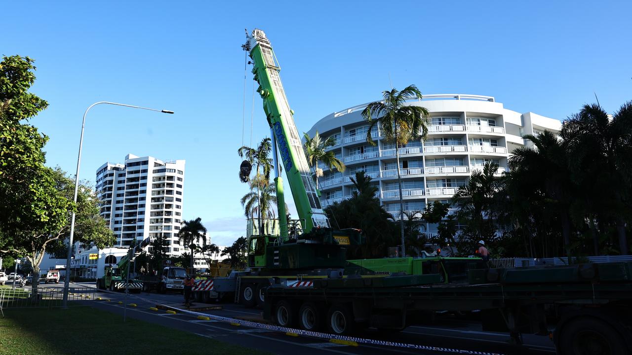 A large crane is erected on the Cairns Esplanade, where a stolen helicopter on an unauthorised flight crash landed into the Double Tree Hilton hotel at about 1:50am Monday, killing the pilot. Picture: Brendan Radke