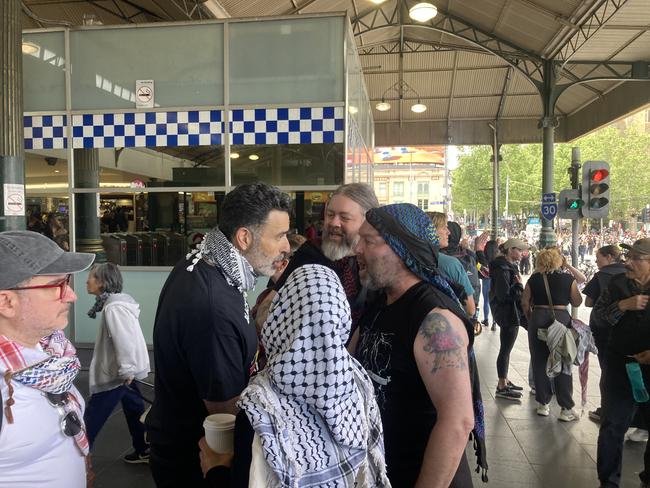 Pro-Palestine rally leader Nasser Mashni implores those engaged in an angry confrontation to stand down. Picture: Angus McIntyre