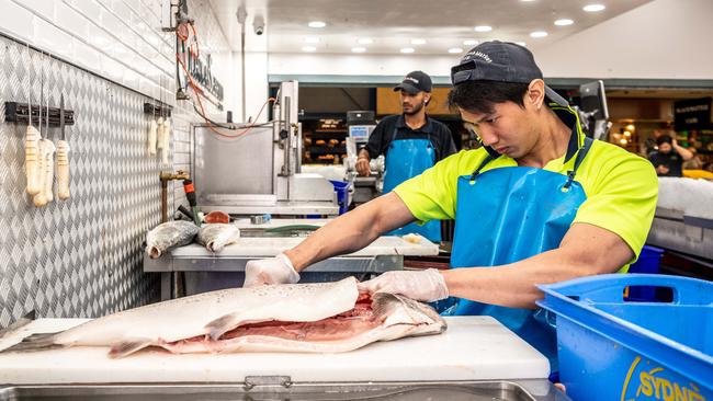 Then Ji Lung fillets a fish at the Sydney Fish Market. Picture: AAP