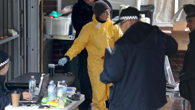 Detectives remove sophisticated drug-production equipment from a clandestine drug laboratory, uncovered at Morphett Vale. Picture Dean Martin