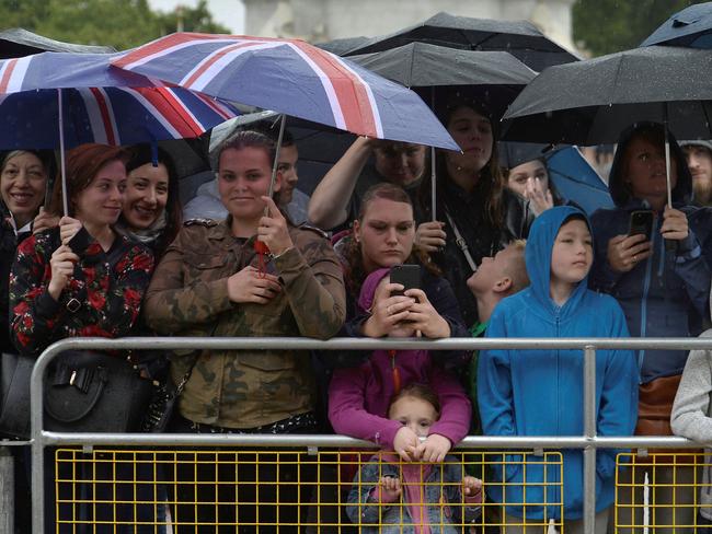 Onlookers watch as Britain's Prince Philip, Duke of Edinburgh, in his role as Captain General, Royal Marines, attends a Parade to mark the finale of the 1664 Global Challenge on the Buckingham Palace Forecourt in central London on August 2, 2017. Picture: AFP.