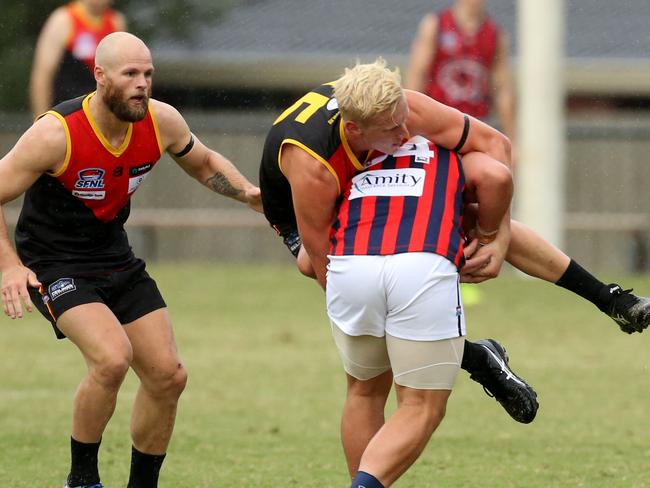 Gotcha: Dingley’s Kris Feehan claims East Malvern’s David Ismail. Picture: Stuart Milligan