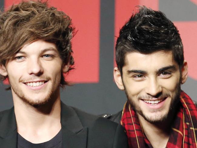 FILE - This Nov. 3, 2013 file photo shows One Direction members Louis Tomlinson, left, and Zayn Malik during an event for their film "One Direction: This Is US," in Makuhari, near Tokyo, Sunday, Nov. 3, 2013. A representative for One Direction says the band’s lawyers are dealing with a video showing two band members smoking what the singers referred to as an “illegal substance.” British tabloid The Daily Mail posted a five-minute clip Tuesday, May 27, 2014, of Zayn Malik smoking and speaking with Louis Tomlinson, who is filming. (AP Photo/Koji Sasahara, File)