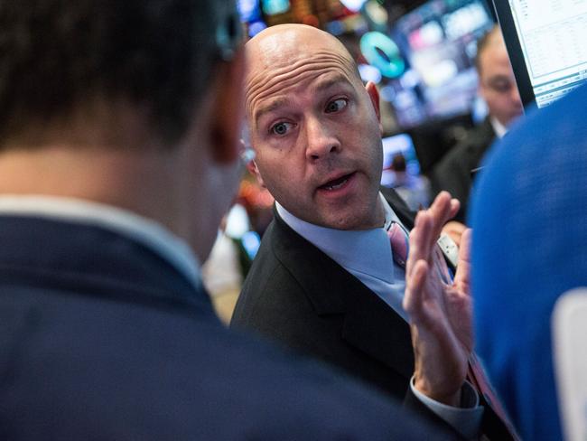 NEW YORK, NY - DECEMBER 11: Traders work on the floor of the New York Stock Exchange during the afternoon of December 11, 2015 in New York City. The Dow Jones Industrial Average closed out more than 300 points down. Andrew Burton/Getty Images/AFP == FOR NEWSPAPERS, INTERNET, TELCOS & TELEVISION USE ONLY ==