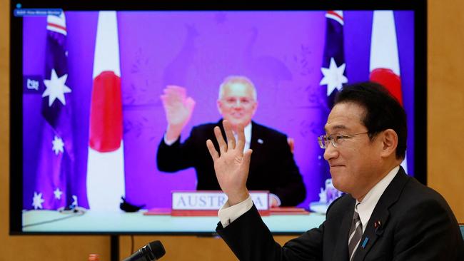 Japan’s Prime Minister Fumio Kishida, right, and Prime Minister Scott Morrison attend a video signing ceremony of the bilateral reciprocal access agreement at Kishida's official residence in Tokyo on January 6, 2022. Picture: Issei Kato / AFP