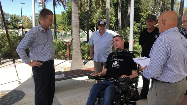 Gold Coast quadriplegic Perry Cross, a pioneer of spinal research and motivational speaker, talking to a City Council representative about plans for ocean pools on the Coast.