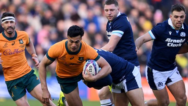 Joseph-Aukuso Suaalii of Australia runs with the ball as he is tackled by Sione Tuipulotu of Scotland during the Autumn Nations Series 2024 match between Scotland and Australia. Picture: Stu Forster/Getty Images