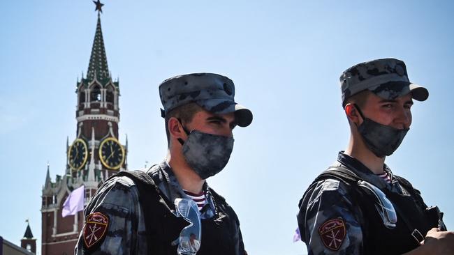 Russian National Guard (Rosgvardia) servicemen wearing face masks walk along Red Square in central Moscow. Picture: AFP