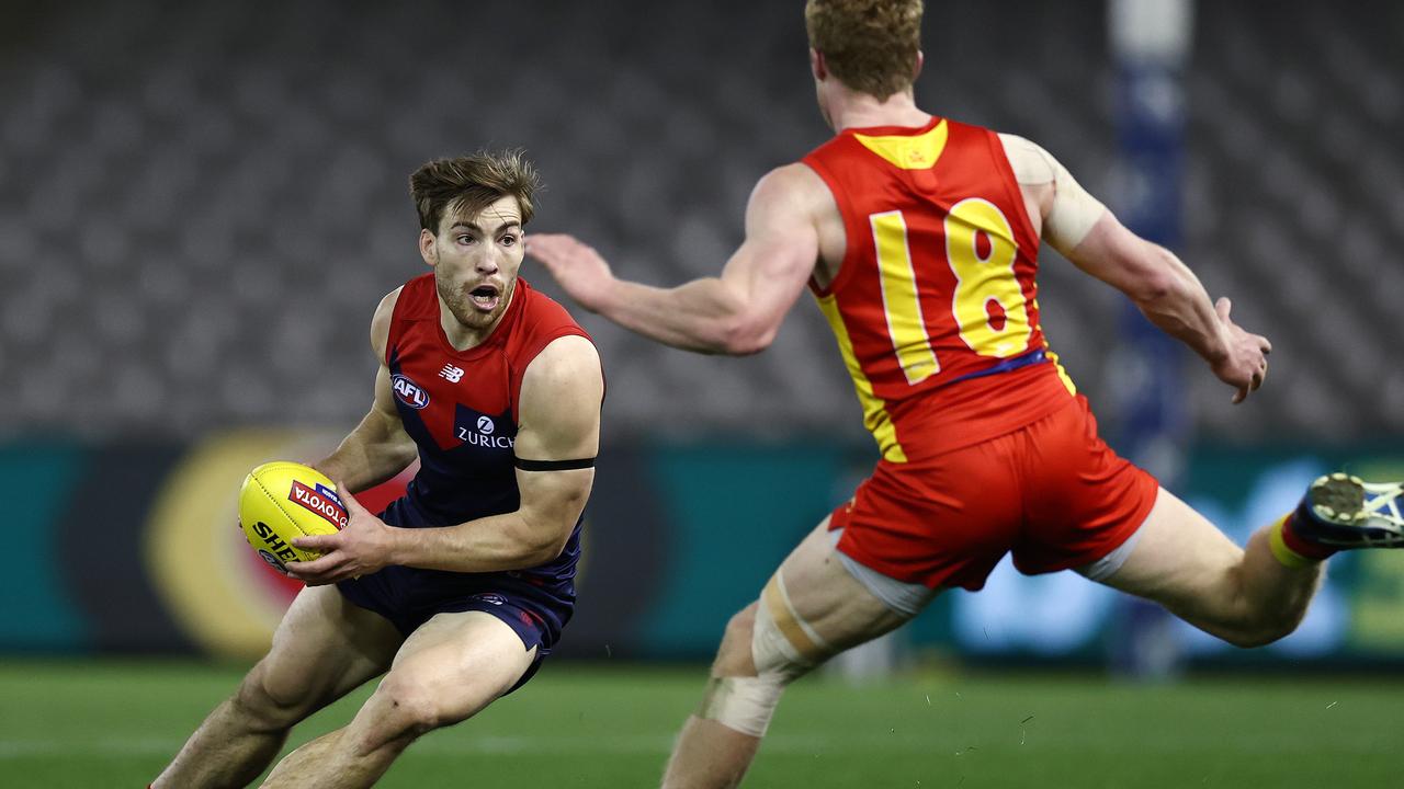 Jack Viney looks to weave his way around Matthew Rowell. Picture: Michael Klein