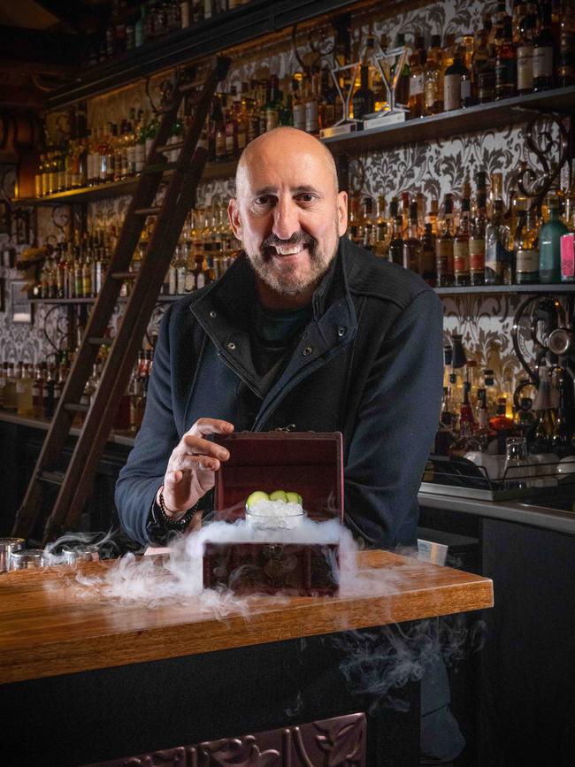Gorge Comorra at his bar 18th Amendment and his signature cocktail ‘’The Boardwalk Empress’“. Picture: Brad Fleet