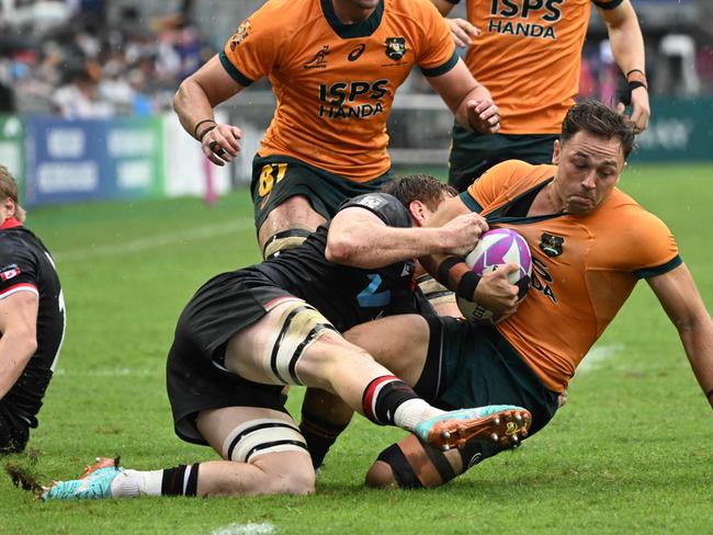 Australiaâ&#128;&#153;s Hayden Sargeant (R) is tackled by Canadaâ&#128;&#153;s Phil Berna (L) in their Pool A match at the 2024 Rugby Sevens Hong Kong tournament at the Hong Kong stadium on April 6, 2024. (Photo by Peter PARKS / AFP)