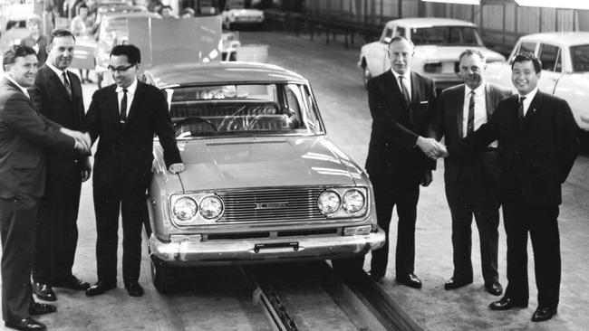 Workers celebrate the production of the 10,000th Australian-made Toyota in the late 1960s. Picture: Supplied.