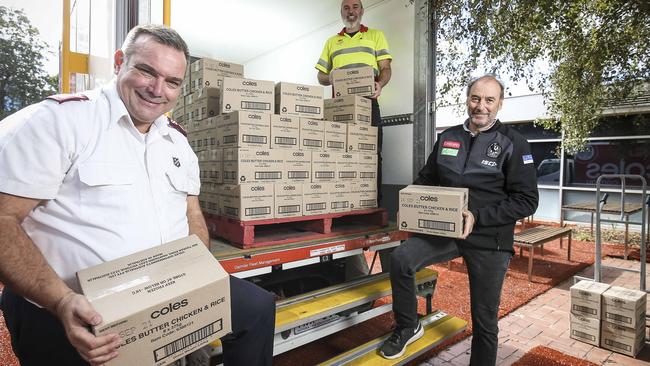 Maj Brendan Nottle (left) and Collingwood Football Club operations director David Emerson receiving supplies from Coles. Picture: Martin Keep.