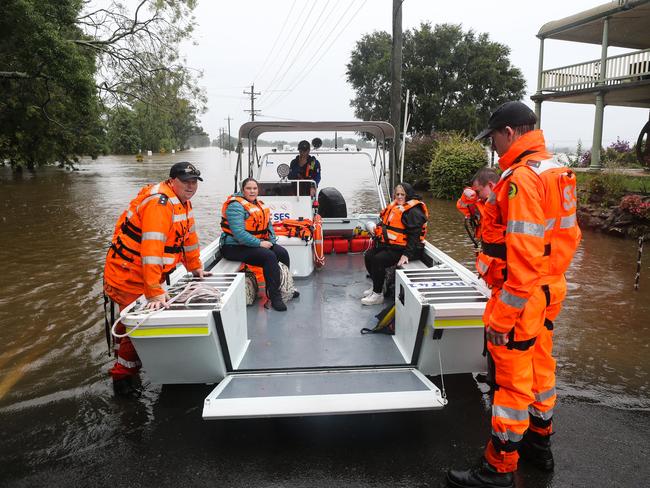 Major flooding in Windsor, Sydney where the bridge has been closed. The SES Crew, Police and Fire Rescue Patrols are working together to load urgent medical supplies, food and other goods on-board the SES boats to be transported across to communities. Picture: NCA NewsWire / Gaye Gerard