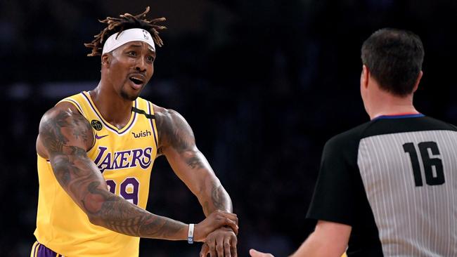 (FILES) In this file photo Dwight Howard #39 of the Los Angeles Lakers argues his foul call with referee David Guthrie #16 during the first quarter at Staples Center on February 21, 2020 in Los Angeles, California. - Los Angeles Lakers center Dwight Howard says he will play when the NBA season resumes in Orlando on July 30, 2020 despite concerns the restart might distract from his social activism. Howard announced his decision to join LeBron James and his other Laker teammates in a CNN appearance late Monday, citing his contract and his hunger to win an NBA crown at age 34. (Photo by Harry How / GETTY IMAGES NORTH AMERICA / AFP)