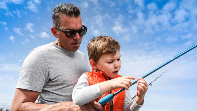 Recreational angler Joshua Quinn with his son Cohen 3, fishing off Grange jetty. Picture AAP/Russell Millard