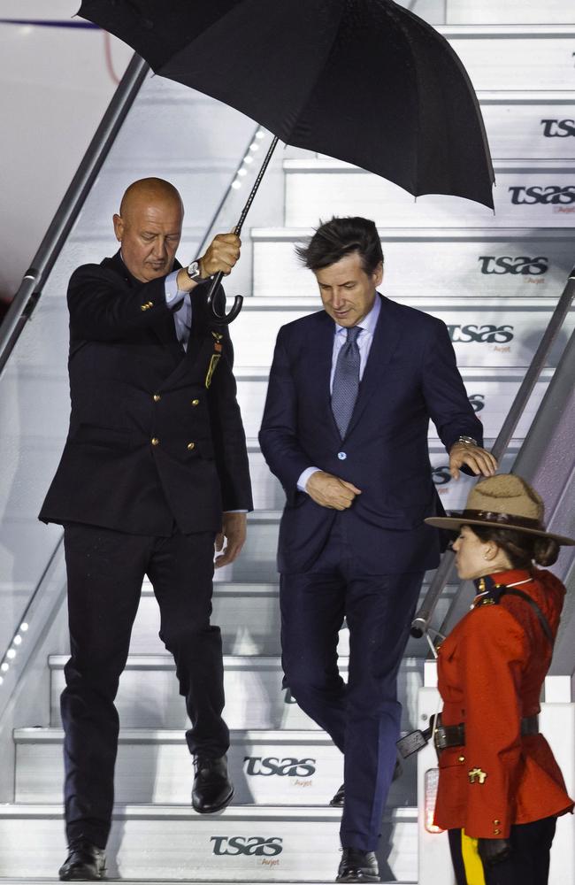 Italian Prime Minister Giuseppe Conte is shielded from the rain by an aide as he arrives in Quebec. Picture: AFP/Geoff Robins