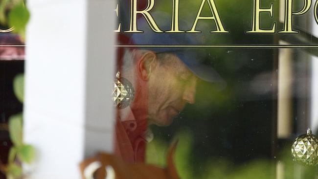 Wayne Bennett hides at a cafe in Brisbane.