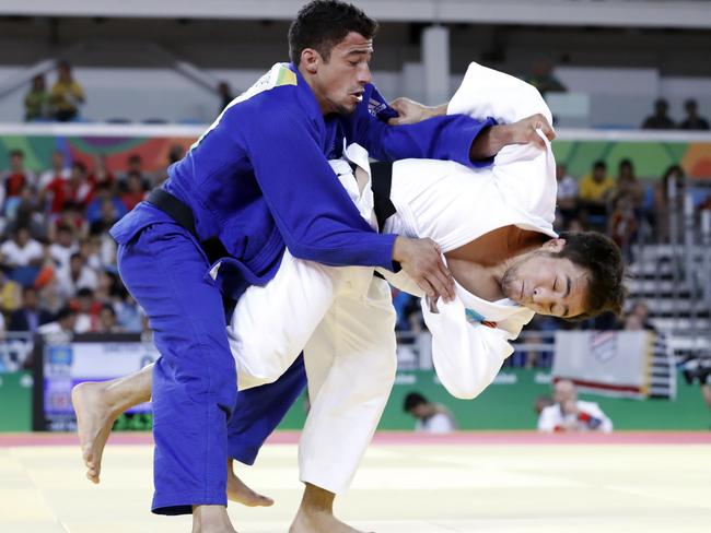 Great Britain's Ashley McKenzie (blue) in action against Kazakhstan's Yeldos Smetov.