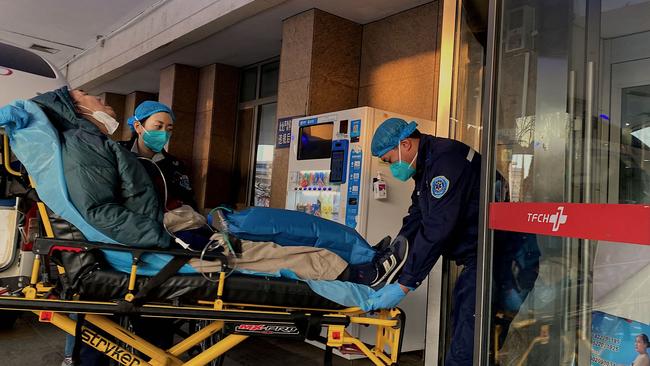 Health workers moving a Covid-19 patient at Tianjin First Center Hospital in Tianjin. Picture: AFP.