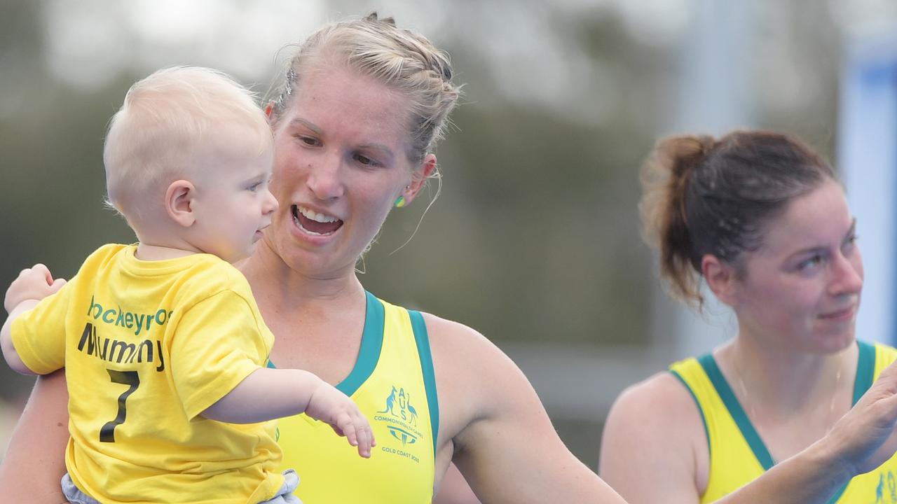 Jodie Kenny of Australia with her baby after the fold medal match against New Zealand.