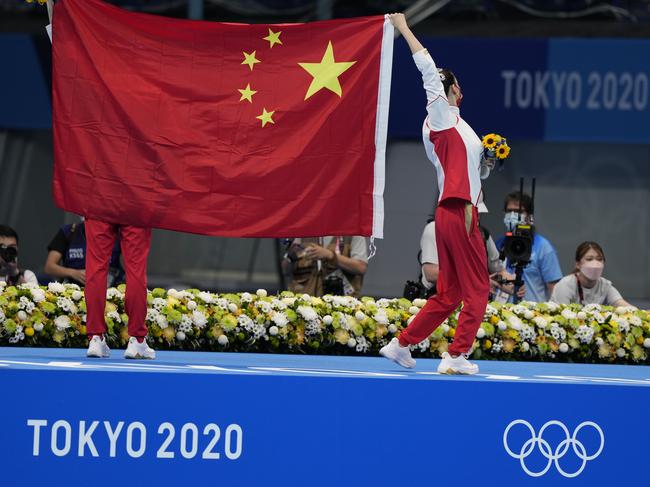 TOKYO, JAPAN - AUGUST 04: Silver medalists Huang Xuechen and Sun Wenyan of Team China celebrate with a Chinese national flag after the Artistic Swimming Duet Free Routine Final medal ceremony on day twelve of the Tokyo 2020 Olympic Games at Tokyo Aquatics Centre on August 4, 2021 in Tokyo, Japan. (Photo by Fred Lee/Getty Images)