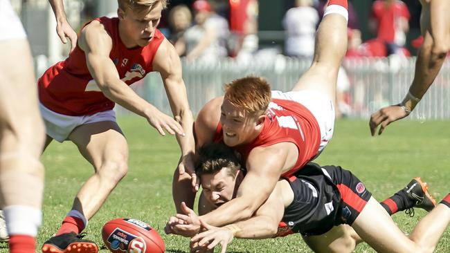 North’s Mitch Harvey climbs over the back of West’s Murray Waite. Picture: AAP/Mike Burton