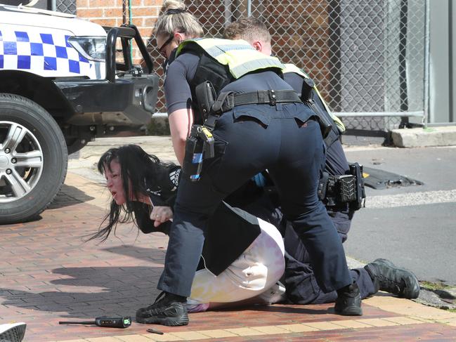 Preston’s distraught partner is restrained by police at the scene of his shooting. Picture: David Crosling