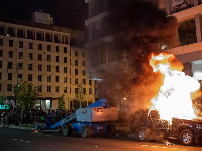 A car set on fire by protesters one block away from the White House. Picture: AFP