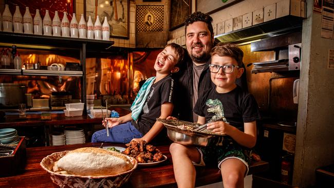 Chef Duncan Welgemoed cooking with his sons Max, nine, and Alex, six, in his restaurant Africola. Picture: Matt Turner