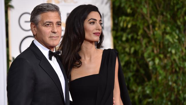 George Clooney and Amal Clooney arrive at the 72nd annual Golden Globe Awards at the Beverly Hilton Hotel.