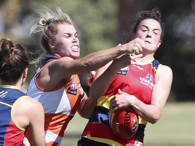 AFLW - Adelaide Crows v GWS at Richmond Oval. Jacinda Barclay punches the ball away from Eloise Jones Picture SARAH REED