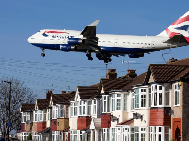 A British Airways 747 aircraft flies over roof tops as it comes into lane at Heathrow Airport. in. Picture: AFP.