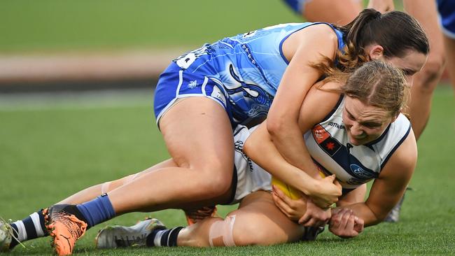 Amy Smith applies one of her 17 tackles to Zali Friswell as the Kangaroos repelled everything the Cats could throw at them. Picture: Felicity Elliott/AFL Photos via Getty Images