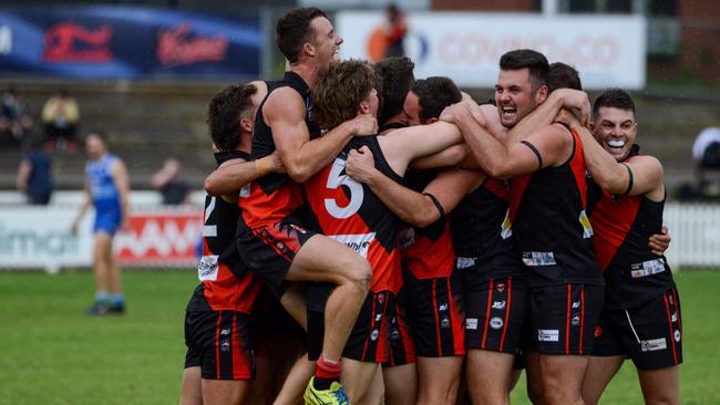 Tea Tree Gully players celebrate their 2020 grand final win over Sacred Heart Old Collegians. Picture: Brenton Edwards