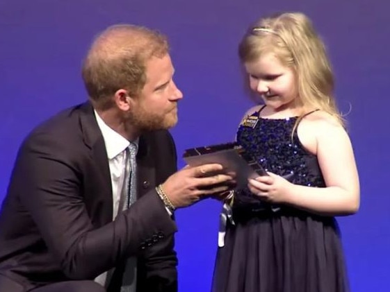 Prince Harry speaks with a thrilled little girl at the WellChild Awards in London. Picture: Supplied