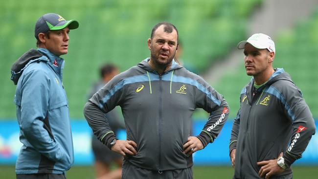 Wallabies coach Michael Cheika talks to assistant coaches Stephen Larkham and Nathan Grey.