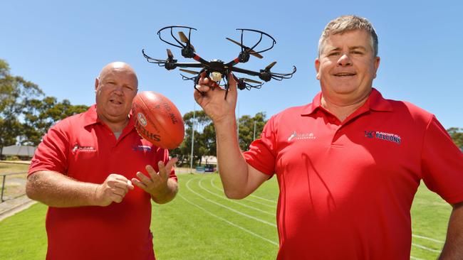 Flagstaff Hill assistant coach Darren Vanzetta (left) and head coach Rod Mitchell with a drone. Picture: AAP/Brenton Edwards.