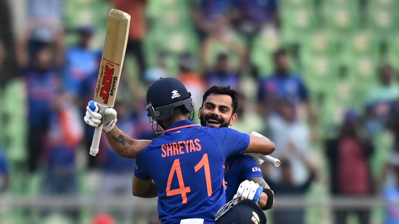 Virat Kohli is congratulated by his teammate Shreyas Iyer after he scored a century (100 runs). (Photo by Arun SANKAR / AFP)