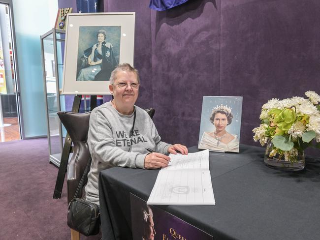 Josephine Smith signs a condolence book for the Queen's passing at Playford Civic Centre. Picture: Brenton Edwards