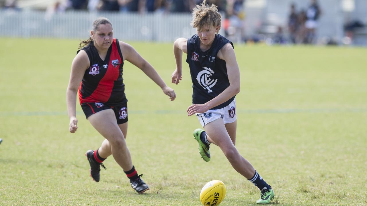 Briseis Nean (left) of South Toowoomba Bombers and Olly Slyderink of Coolaroo in U14 AFL Darling Downs grand final at Rockville Park, Saturday, September 2, 2023. Picture: Kevin Farmer