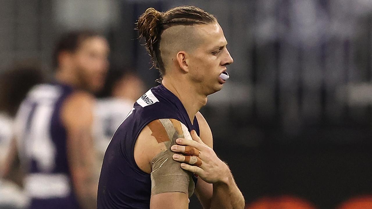 PERTH, AUSTRALIA - JULY 15: Nat Fyfe of the Dockers holds his injured shoulder during the round 18 AFL match between the Fremantle Dockers and Geelong Cats at Optus Stadium on July 15, 2021 in Perth, Australia. (Photo by Paul Kane/Getty Images)