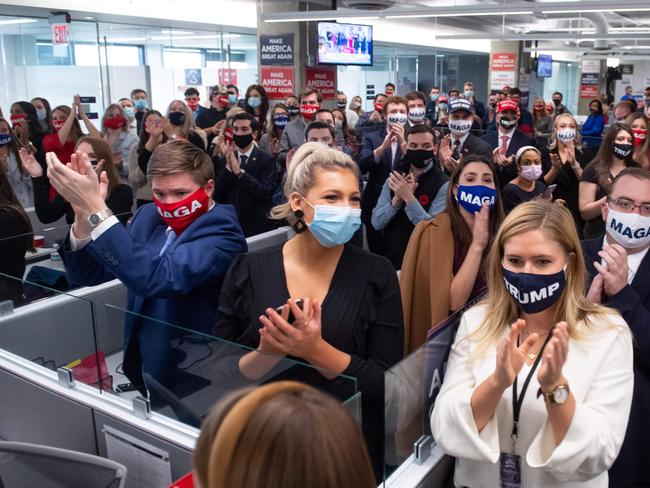 Campaign workers applaud as US President Donald Trump visits his campaign headquarters. Picture: AFP